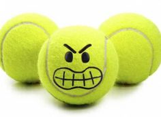 three tennis balls with faces drawn on them, one is yellow and the other is black