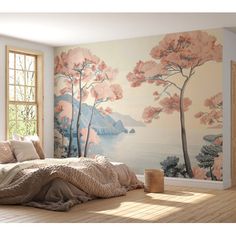 a bed sitting under a window next to a wall mural