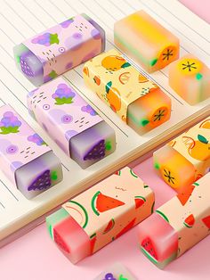 several different types of soaps sitting on top of a table next to a notebook