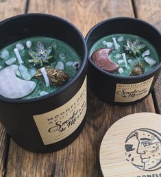 two buckets filled with green liquid sitting on top of a wooden table next to a coaster