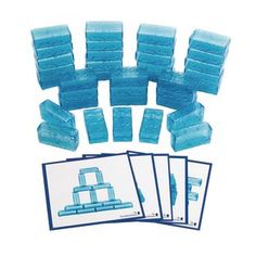 some blue ice cubes and cards on a white background