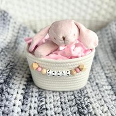 a pink stuffed animal sitting in a basket