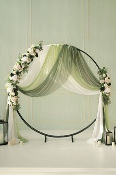 a wedding arch decorated with flowers and candles