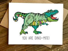 a greeting card with an image of a dinosaur wearing a party hat and saying you're not old, you're dino - mite