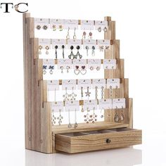 a wooden display with earrings on it