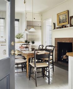 a dining room table with chairs and a fire place