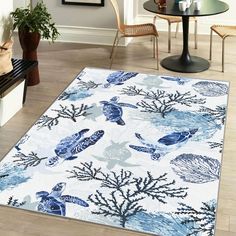 a blue and white area rug with sea creatures on it in a living room setting