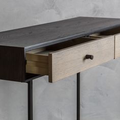 a wooden desk with two drawers on one side and an open drawer on the other