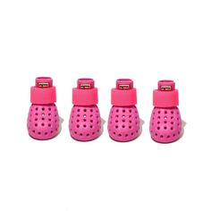 three small pink baby shoes sitting next to each other