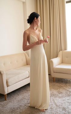 This maxi dress is made of satin and features a v neckline, thin, adjustable, crossed shoulder straps on the back, a side zipper closure, a flowy fit and a light, soft, shiny material. This maxi dress comes in light beige. Also available for made-to-order (MTO) in other colors and sizes. Please send us an inquiry. Beige Flowy Dress, Loose Prom Dress, Silk Flowy Dress, Flowy Satin Dress, Bridal Fits, Flowy Silk Dress, Maxi Silk Dress, Cream Linen Dress, Womens Lounge