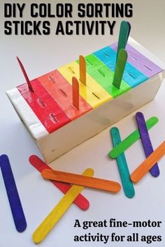 colorful pops sticks sitting on top of a wooden box with the words diy color sorting sticks activity