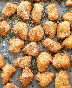 some food that is sitting on a pan covered in powdered sugar and sprinkled with parsley