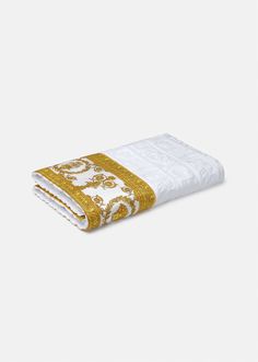 a white and gold towel on a white surface