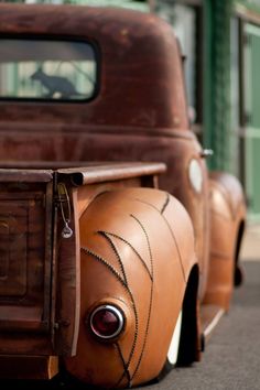 an old fashioned truck is parked on the street