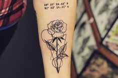 a rose tattoo on the arm with coordinates