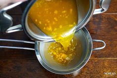 a person pours corn into a strainer