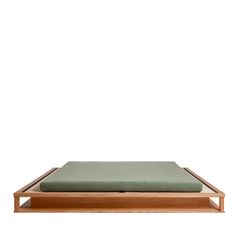 a wooden platform with a green cushion on top