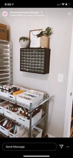 a metal shelf filled with lots of bottles and other items next to a wall mounted mirror