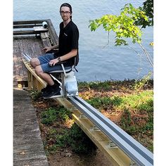 a man sitting on top of a wooden dock