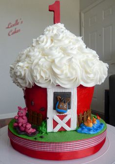 a cake that is shaped like a barn and has white frosting on the top