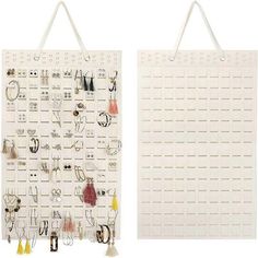 two white wall hangings with earrings on them