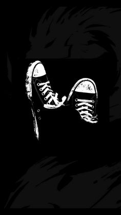 a black and white drawing of a pair of shoes on top of each other in the dark