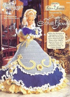 a crocheted doll in a blue and yellow dress