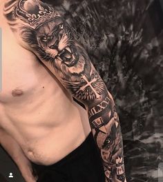 a man with a lion and cross tattoo on his arm