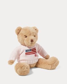 a teddy bear wearing a pink sweater with the american flag on it's chest