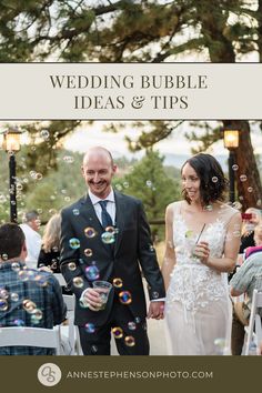 a bride and groom walking down the aisle with bubbles in front of them