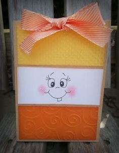 an orange and white card with a smiling face