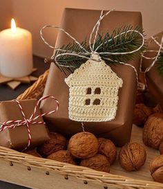 presents wrapped in brown paper and tied with twine are sitting on a table next to nuts