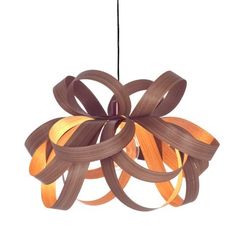 a light that is made out of wood and has orange ribbons hanging from the ceiling