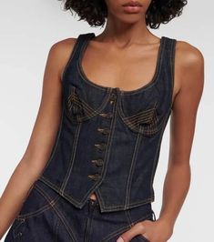 Material: 100% cotton.Care instructions: hand wash.Made in Italy.Designer color name: Indigo.Closure: buttoned front.True to size.Fitted.Non-stretchy fabric.Cropped.The model seen in the picture is 178cm-5'10' and wearing a size FR 36 Fitted Dark Wash Corset, Fitted Dark Wash Top With Buttons, Dark Wash Fitted Top With Buttons, Spring Fitted Corset With Buttons, Fitted Vintage Dark Wash Tops, Vintage Fitted Cotton Corset, Fitted Corset With Button Closure, Jean Paul Gaultier Denim, Denim Bustier Top