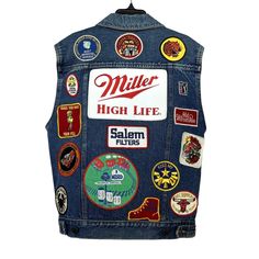 "1980s Patched Denim Vest Jacket | Miller High Life Patch | Vintage Super cool patched denim vest! Has a \"Miller High Life\" patch on the back. Super fun to style with and add over any outfit! Measurements Bust: 37\" Waist: 32\" Length: 22.5\" Shoulder to Shoulder: 16\" Condition: Excellent vintage condition!" Retro Cotton Outerwear With Patches, Retro Cotton Denim Jacket With Patches, Retro Denim Jacket With Patches For Fall, Vintage Denim Outerwear With Embroidered Patch, Vintage Outerwear With Patches In Medium Wash, Vintage Medium Wash Outerwear With Patches, Retro Denim Jacket With Patches, Vintage Upcycled Denim Outerwear, Retro Denim Jacket With Patches For Streetwear