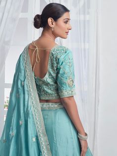 Introducing our precious sky-blue embroidered organza bridesmaid lehenga choli, a stunning ensemble that will make you stand out at any event or special occasion. This beautiful lehenga set features a sky-blue color organza lehenga with intricate multi-embroidered work and sequin detailing, paired with a matching choli and dupatta that also boasts beautiful embroidery and sequin work. The designer lace work on the dupatta adds an elegant touch to the overall look.
This lehenga choli set includes Light Blue Semi-stitched Lehenga With Resham Embroidery, Light Blue Organza Gown For Wedding, Elegant Light Blue Lehenga For Reception, Light Blue Organza Wedding Gown, Embroidered Chanderi Lehenga For Wedding, Wedding Embroidered Chanderi Lehenga, Light Blue Resham Embroidery Choli For Wedding, Light Blue Semi-stitched Dress With Intricate Embroidery, Semi-stitched Light Blue Dress With Intricate Embroidery