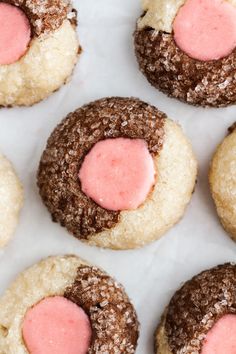 some cookies with pink frosting on top of them