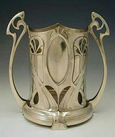 an ornate silver cup on a white background