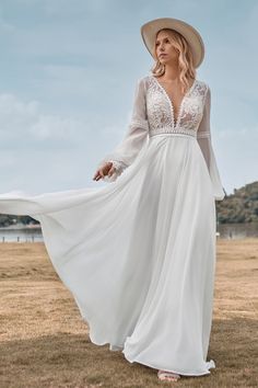 a woman wearing a white dress and hat