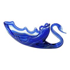 a blue glass swan sculpture sitting on top of a table