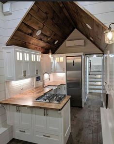 a kitchen with an oven, refrigerator and sink inside of the house that is built into the ceiling