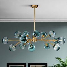 a modern chandelier with blue glass balls hanging from the ceiling