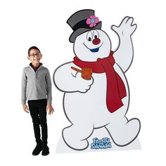 a person standing next to a snowman sign