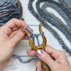 someone is working with yarn and scissors to make something look like an ornament