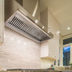 a stove top oven sitting inside of a kitchen