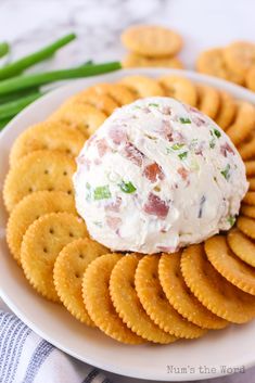 a white plate topped with crackers and a cheese ball