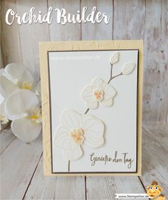 a card with some flowers on it and the words, orchid builder written in gold