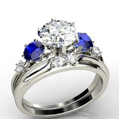 a diamond and blue sapphire engagement ring with matching wedding band, set in 18k white gold