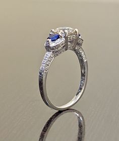 DeKara Designs Collection Beautiful Modern/Art Deco Diamond Blue Sapphire Pave Set Engagement Ring. Metal- 90% Platinum, 10% Iridium. Stones- 1 Genuine Round Diamond K-L Color VS1-VS2 Clarity 1.01 Carats, 96 Round Diamonds H-I Color SI1 Clarity 0.52 Carats, 2 Special Cut Trapezoid Blue Sapphires 0.40 Carats. Size- 6 1/2. FREE SIZING A Jaw Drop Gorgeous Art Deco Inspired Round Diamond Center Special Cut Blue Sapphire Diamond Engagement Ring Handmade in Platinum. There is a beautiful expertly pron Wedding Ring Platinum, Sapphire Diamond Engagement Ring, Art Deco Diamond Ring, Deco Diamond Ring, Diamond Sapphire Engagement Ring, Engagement Ring Platinum, Sapphire Diamond Engagement, Round Diamond Engagement Ring, Art Deco Diamond Rings