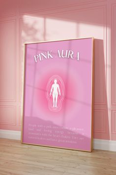 a pink poster with the words pink aura on it in front of a wooden floor